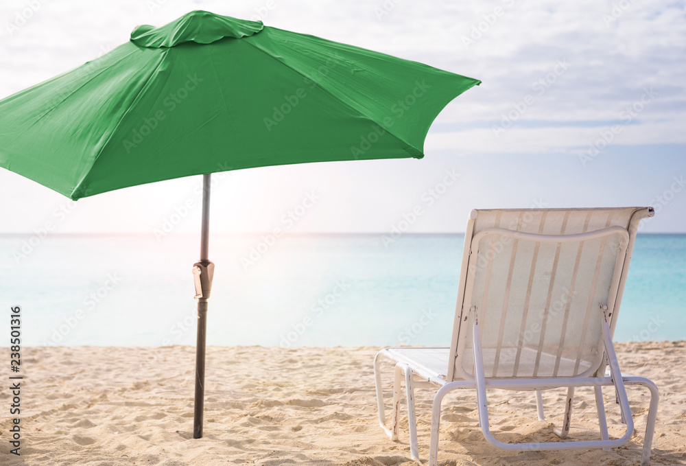 White chairs and umbrella on a beach