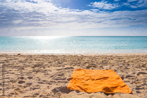 Orange towel on beatiful tropical beach