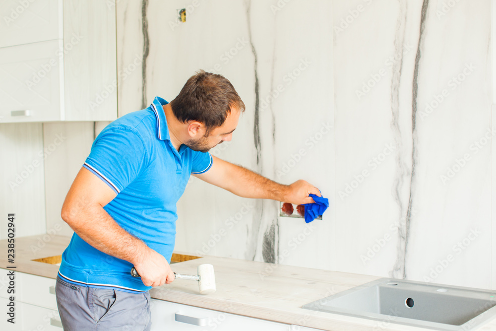 Skilful husband cleaning after self kitchen renovation Skilful husband cleaning after self kitchen renovation