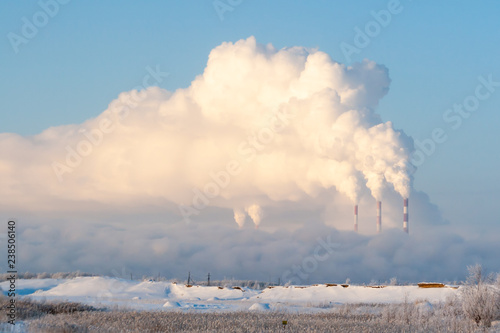 Pipes of thermal power plants emit thick smoke. Thermal power plants in thick fog.