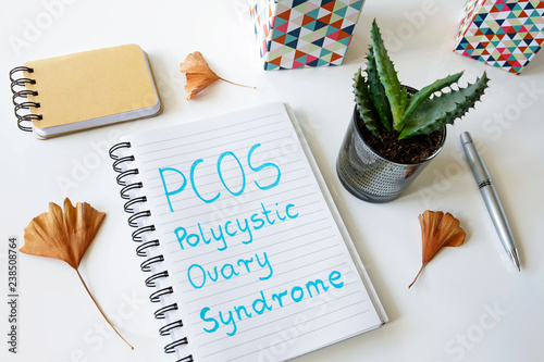 PCOS Polycystic ovary syndrome written in a notebook on white table photo