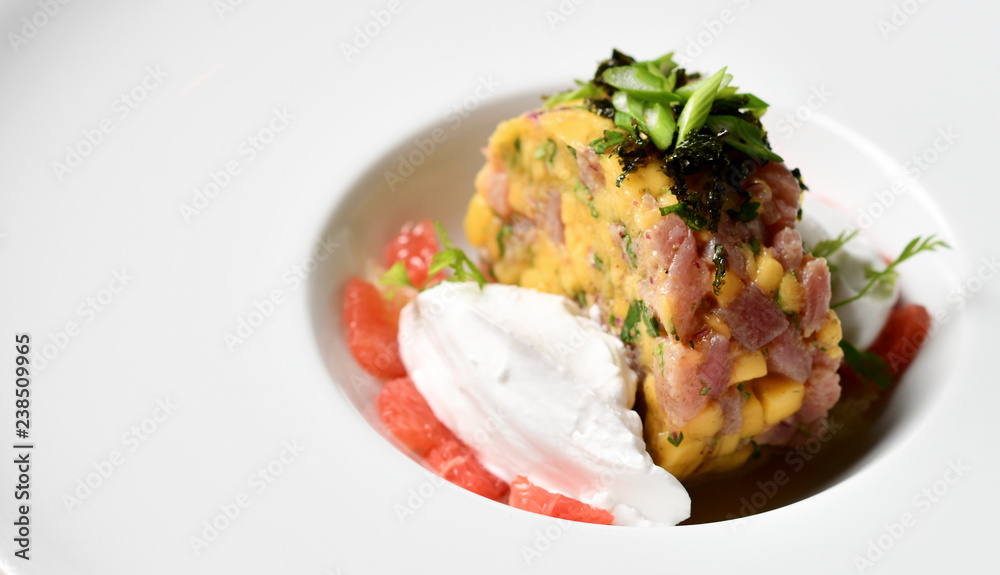 Seafood tuna tartar salad on white plate Seafood tuna tartar salad on white plate
