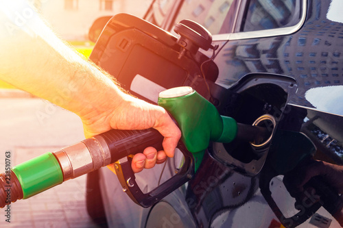 Fotografia Refueling the car at a gas station fuel pump