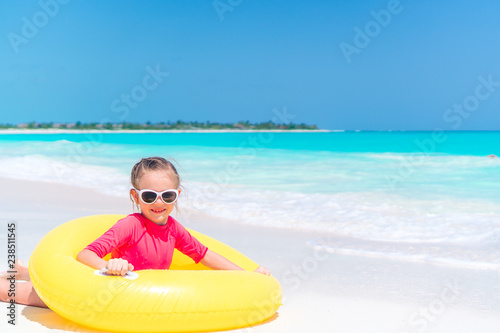 Adorable little girl having fun on the beach