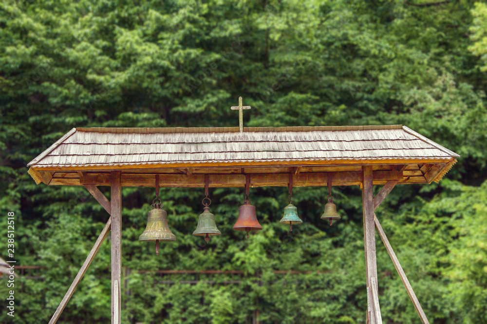 church bells under a canopy in the courtyard of the church church bells under a canopy in the courtyard of the church
