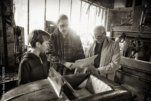 Multi generation family in aDIY workshop to repair a pedal car