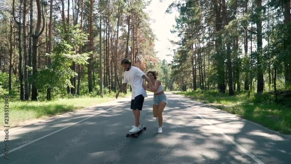 couple having fun with skate on an empty road. couple having fun with skate on an empty road.