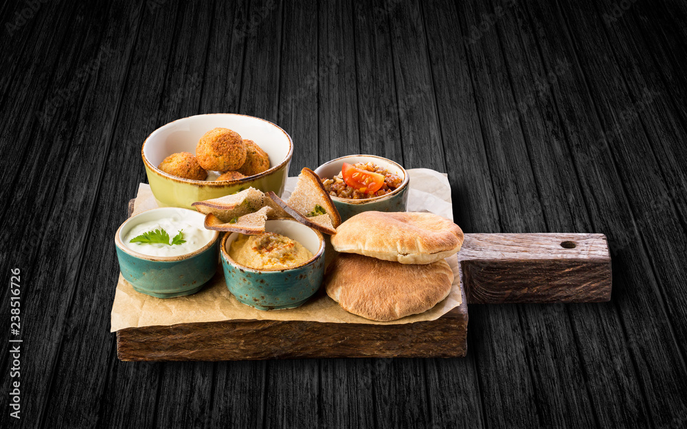 assorted snacks on wooden Board on black wooden background assorted snacks on wooden Board on black wooden background