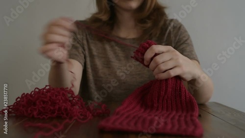 Woman unravelling her knitting