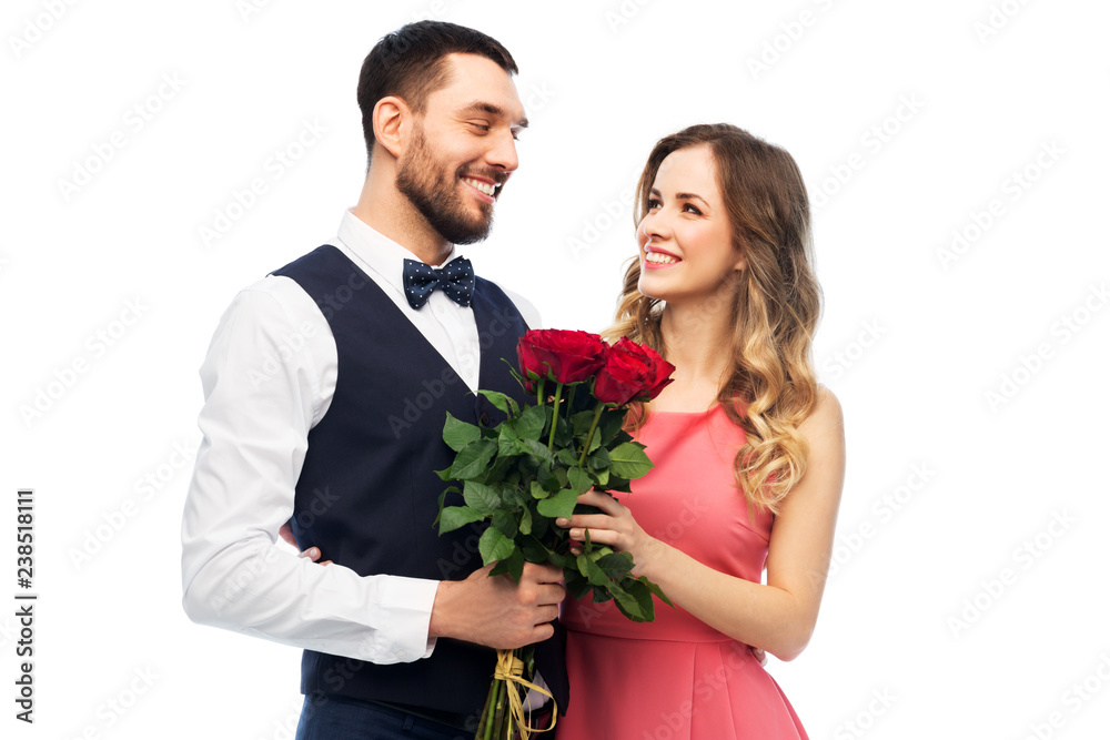 valentines day, relationships and people concept - happy couple with bunch of flowers hugging