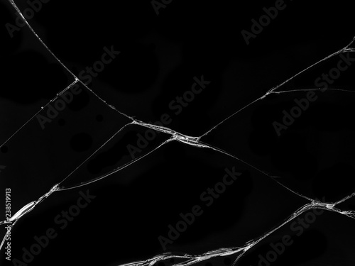 Cracked glass texture on black background. Isolated realistic cracked glass effect.