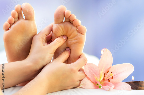 Canvas Print Close up reflexology massage on feet.