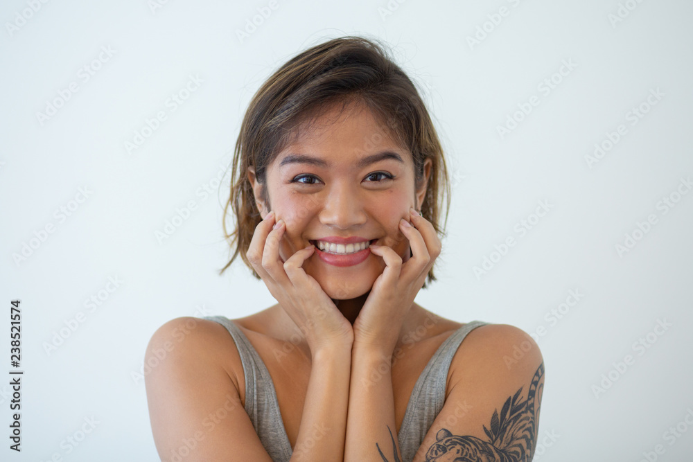 Portrait of cheerful young woman looking at camera and smiling. Asian girl  with tattoo on arm posing isolated. Beauty concept Stock Photo | Adobe Stock