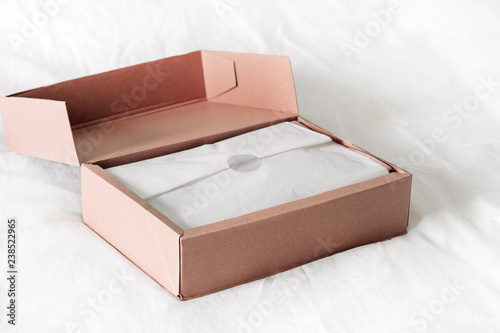 Online shopping fashion items opening box on a white background with copy space