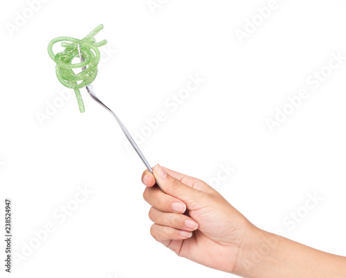 hand holding fork Jelly sweet, dessert colorful with sugar on plate isolated on white background. photo