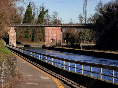 iron bridge on the canal that crosses the Ticino Park flanked by a cycle path photo