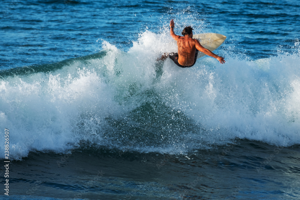 Experienced surfer rides ocean wave on Oahu's North Shore, Hawaii Experienced surfer rides ocean wave on Oahu's North Shore, Hawaii