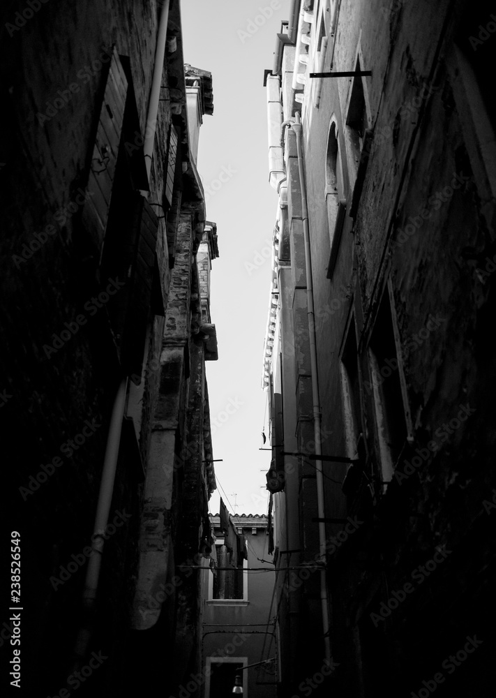 Narrow dark streets of Venice. Black and white