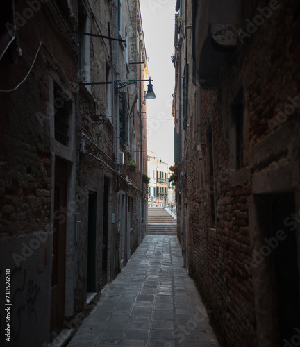 Narrow dark streets of Venice. Brick walls © KONSTANTIN SHISHKIN