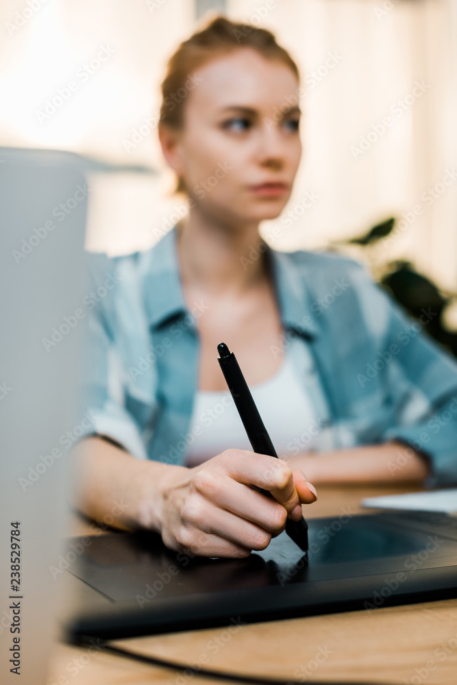 close-up view of young female retouching using drawing tablet at workplace close-up view of young female retouching using drawing tablet at workplace