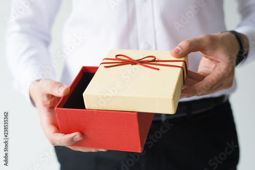 Принти на полотні Closeup of business man opening gift box