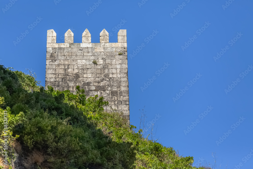 View of tower on medieval wall in granite stone, on Porto, Portugal