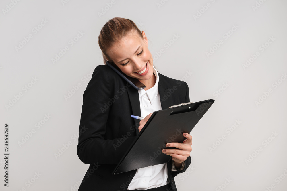 Smiling blonde business woman standing isolated Smiling blonde business woman standing isolated