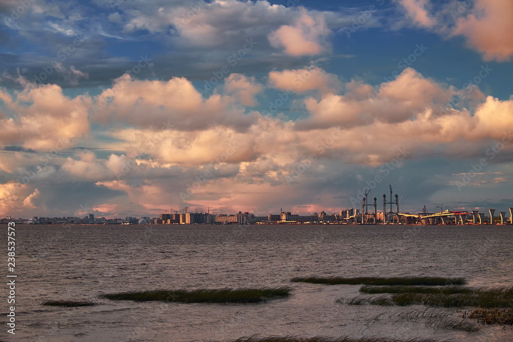 Fototapeta premium Sea landscape with bridge road construction and cranes on horizon in sunset light