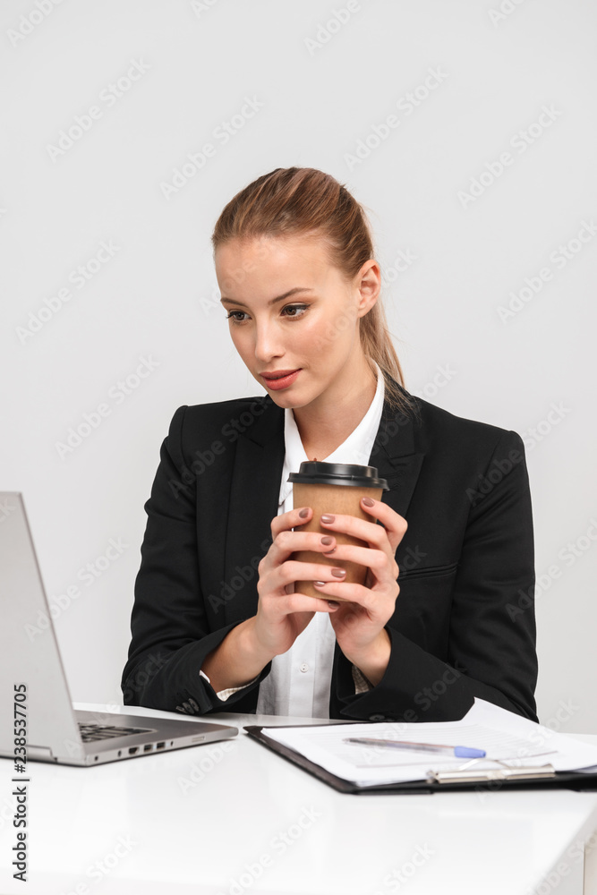 Pretty young business woman wearing suit isolated Pretty young business woman wearing suit isolated