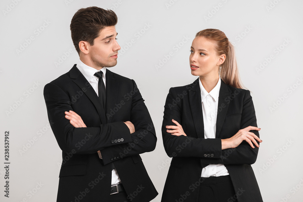 Confident young business couple standing Confident young business couple standing