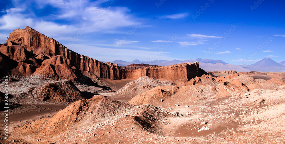 Iconic rock formation in valle de la luna near San Pedro de Atacama feat. vulcano Licancabur in the background - obrazy, fototapety, plakaty 