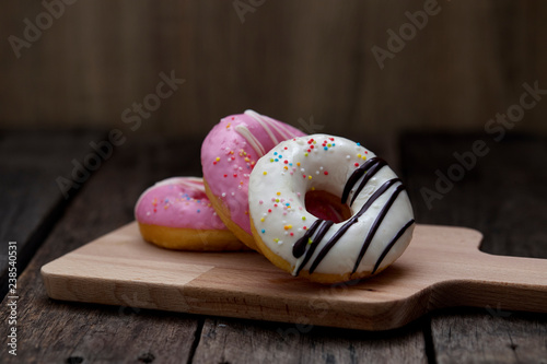 Glazed mini donuts on wooden background
