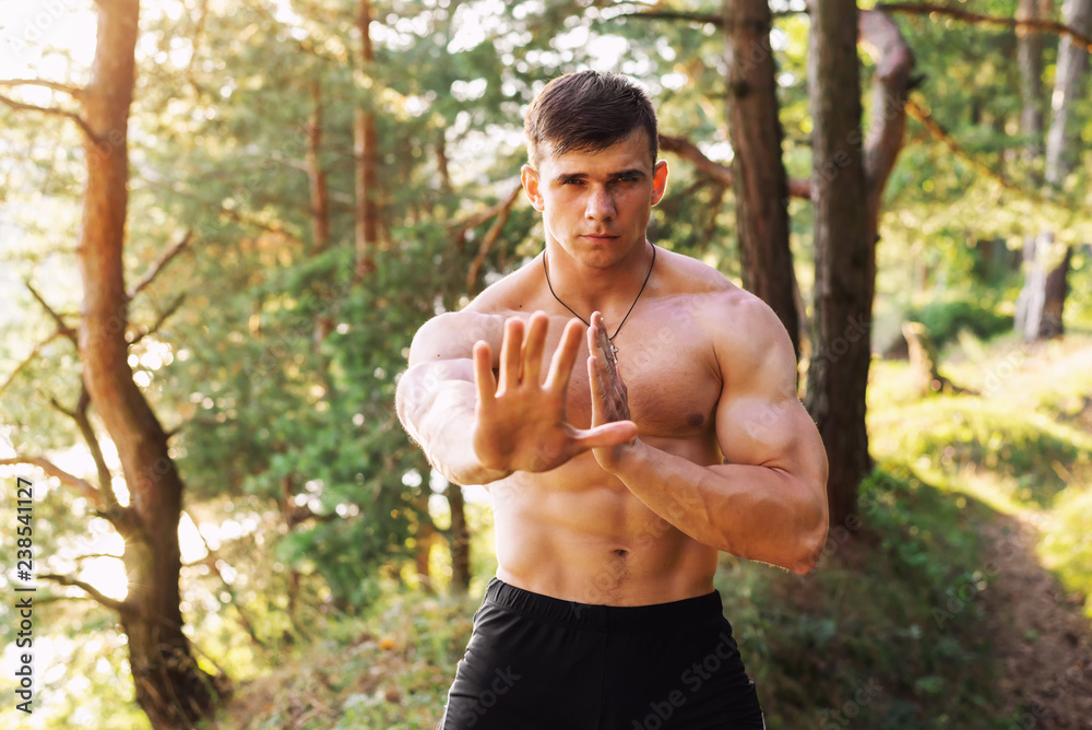 Muscular athletic sportsman in training outdoor Muscular athletic sportsman in training outdoor