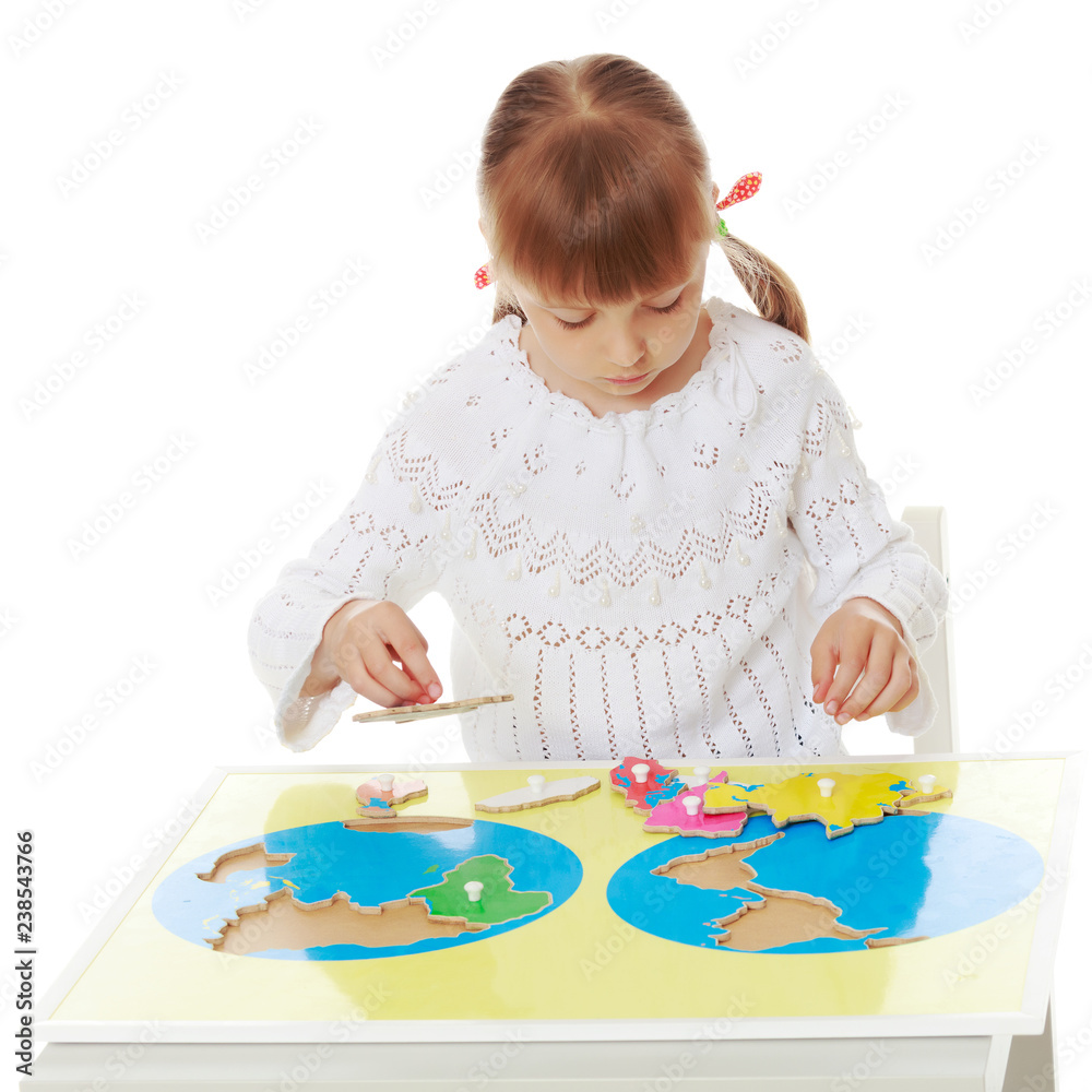 A little girl is studying Montessori stuff. A little girl is studying Montessori stuff.
