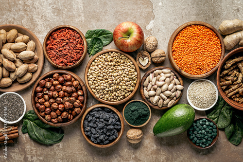 top view of superfoods, legumes and healthy ingredients on rustic background