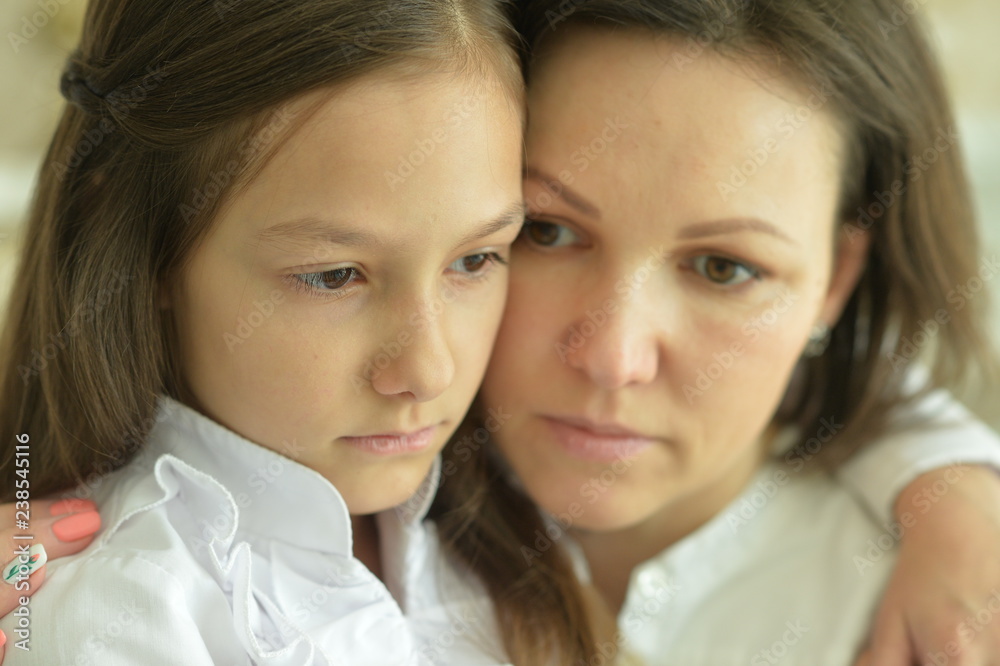 Close up portrait of sad woman and girl Close up portrait of sad woman and girl