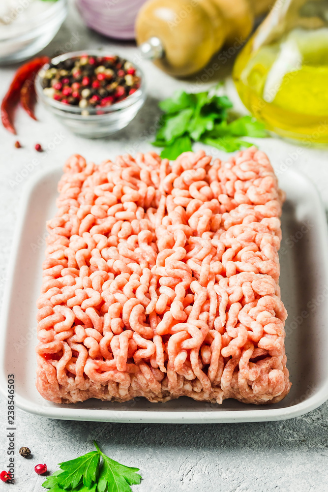 Minced meat, herbs, oil salt and pepper. Selective focus, space for text. Minced meat, herbs, oil salt and pepper. Selective focus, space for text.