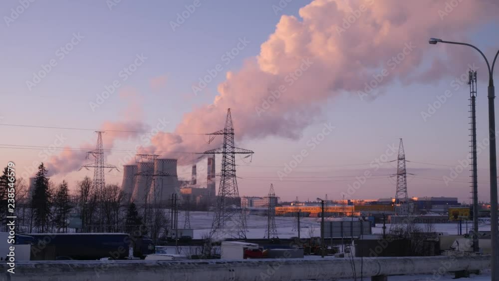 Smoke and steam rising up higher and higher into the winter sky from three pipes of an electric station 4K camera motion slow mo Smoke and steam rising up higher and higher into the winter sky from three pipes of an electric station 4K camera motion slow mo