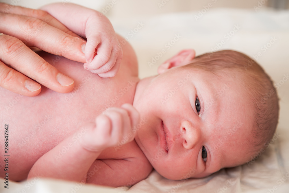 close-up portrait of a newborn baby holding father's finger
