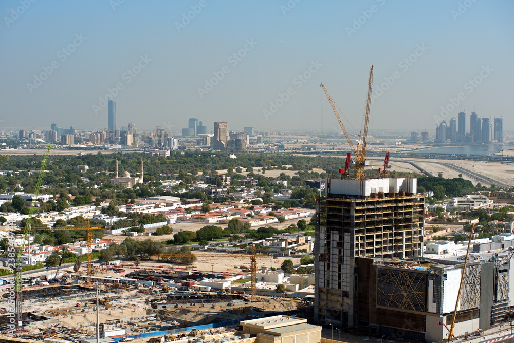 Naklejka premium Aerial view of under construction building with cranes from downtown, visible whole Zabeel district, Dubai Creek harbor, Dubai Canal to Business Bay and Al Khail road