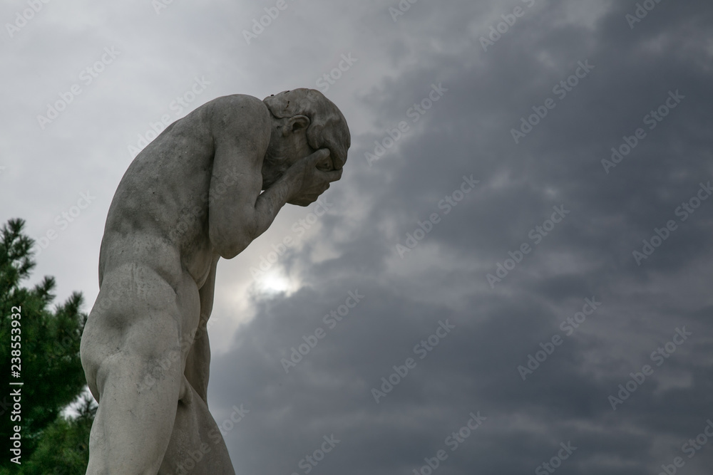 Fototapeta premium posąg mężczyzny trzymającego twarz w ogrodzie Tuileries w Paryżu