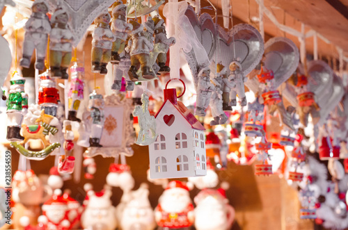 hanging wooden and ceramic toys on the street christmas market © Oksana Mamba