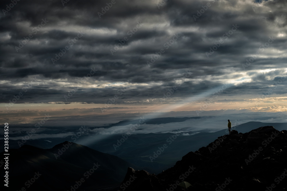 Russia, Upper Baksan Valley, Caucasus, Mount Elbrus, Mountaineer looking down from North Camp Russia, Upper Baksan Valley, Caucasus, Mount Elbrus, Mountaineer looking down from North Camp