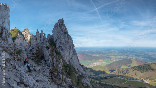 Germany, Upper Bavaria, Aschau, female hiker sitting on viewpoint of Kampenwand photo