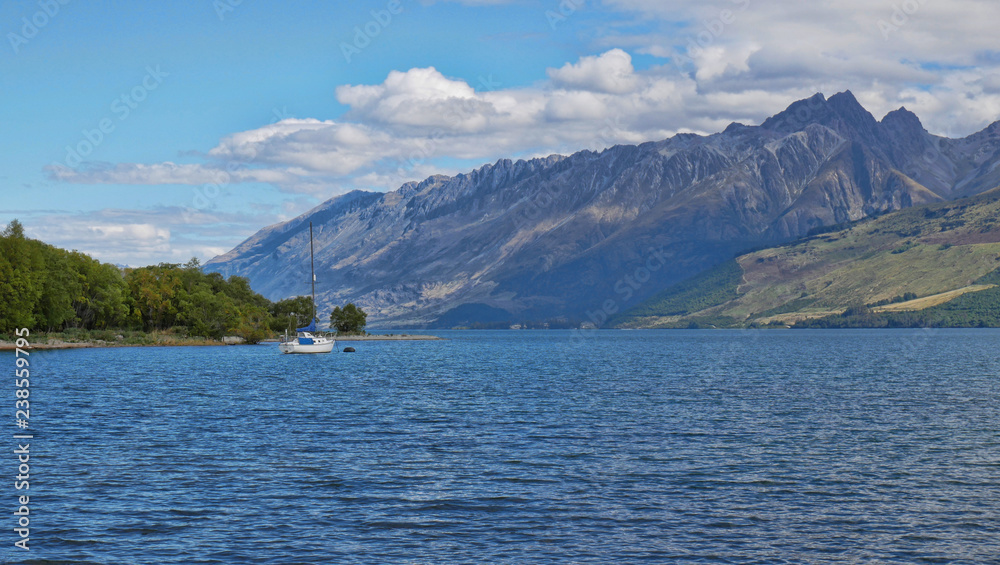 New Zealand sailboat in the Lake District with rugged mountains in the background New Zealand sailboat in the Lake District with rugged mountains in the background