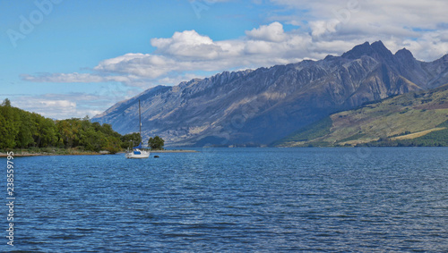 New Zealand sailboat in the Lake District with rugged mountains in the background