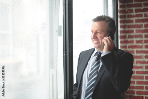 smiling business men talking on the phone © yurolaitsalbert