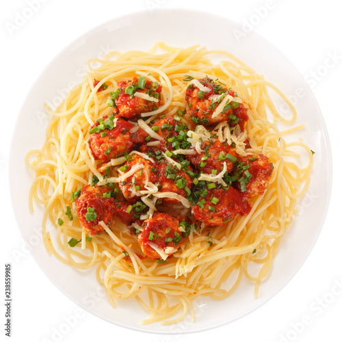 Spaghetti with meatballs with tomato sauce and cheese. Isolated on white background. View from above.