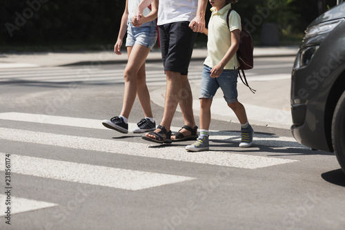 Valokuvatapetti Children crossing the street with their father