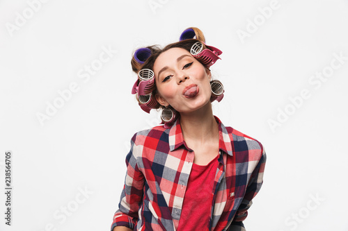 Confident housewife wearing curlers standing